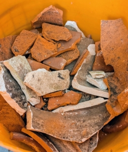 We save all the shards from broken clay pots for covering the inside bottom holes when planting.