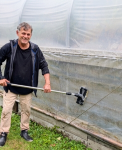 Here's Fernando cleaning the outside of all the hoop houses.
