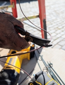 Pete cuts two two-foot lengths of wire.