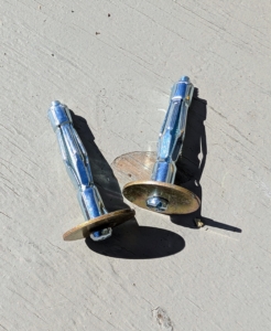 Pete also gets two appropriate washers and secures one on each of the anchoring screws.