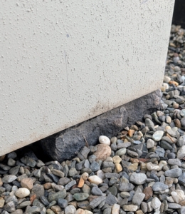 As containers are positioned, bricks or wood shims are placed underneath for drainage.