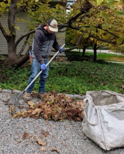 Alex uses a soft rake to gather any debris from the carriage road. After the season, it is also a good idea to clean any well-used summer tools before storing.