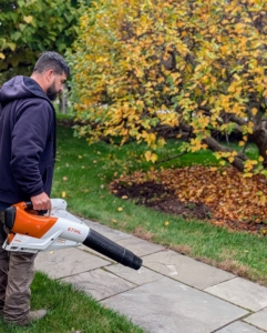 Adan blows the leaves to one area, so he can mow the grass in front my studio. Here he is using a battery powered handheld blower from STIHL - powerful, but much quieter than other blowers.