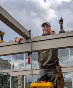 Here's my property manager, Doug, securing a beam and checking all the cross pieces being used. He is also an excellent carpenter and will cut any new rafter tails needed for the project.