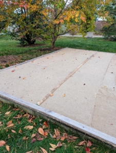 I keep all my air conditioners in large pits, where they are well hidden behind each house. These air conditioner pits are covered with industrial strength plastic, plywood, and then burlap to protect them from the winter elements. Covering these pits also makes them easier to maintain. Any snow or debris that falls can be brushed to the side before accessing the units below.