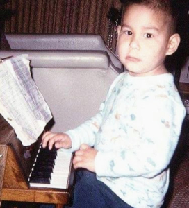 Tim as a child at his first piano.