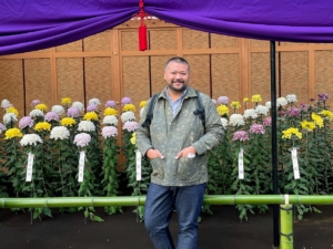 Here I am with the Ogiku or large-flowered chrysanthemums. Each plant was trained to support just one single jumbo flower. So you have some sense of scale, I am nearly 6'3" - these blooms were massive!