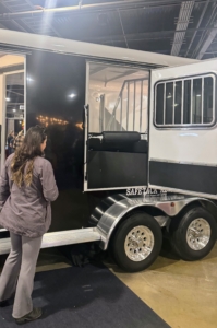 Here is Helen looking at one of the newest trailers, which offers more room and tack storage space.