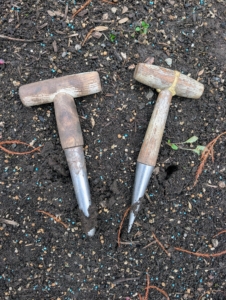 For planting smaller bulbs, my gardeners use T-handled dibbers, which are pressed into the soil to make narrow holes.