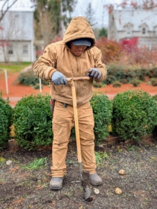 Using the stand-up bulb planter, Phurba is able to make holes faster without kneeling.