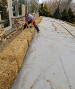 Each standard two-string hay bale weighs between 40 and 75 pounds each - they will keep the tarp in place nicely.