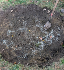 Phurba then mixes the fertilizer with the existing soil.