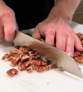 As part of the preparations, Matt chops several bags of pecans for the pecan pies and the chocolate pecan tarts.