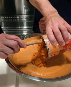 Here's Matt pouring in the pumpkin for the maple bourbon pumpkin pies. I need enough filling for at least eight.