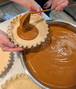 For the pumpkin, the filling is poured carefully into the chilled pie crust. I asked Matt to hold the crust on the edge of the metal bowl to prevent unnecessary drips. I am using my square ladle - it's part of my kitchen tool set at my shop on Amazon.