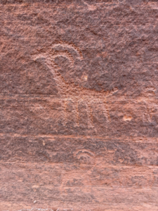 This is called a petroglyph, which is made by carving directly on the rock surface exposing the lighter colored rock underneath. Petroglyphs date back thousands of years. They have been found in all parts of the world except Antarctica. Creating these rock engravings decreased largely after the introduction of other precursors of writing systems and storytelling art forms.