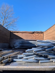 These pipes, which I keep organized in a back field where I store other supplies, are made from rolled galvanized 16 gauge industrial tubing. They are actually the metal parts of greenhouse hoop houses.