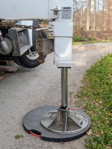 The crew prepares the crane so it is level on the ground and very secure. This is called an outrigger, which is an extendable support that adds stability to the crane during lifting operations.