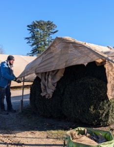 Adan carefully pulls it over the metal ends, so the fabric doesn't snag and rip.
