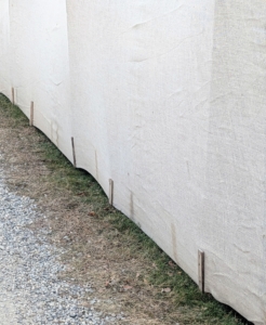 It looks very tidy once several strips are well attached. Both the metal piping and wood stakes can be seen through the fabric.