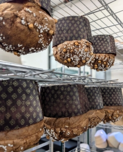 Here are rows of panettone cooling on the racks. If not done properly, the panettone could collapse.