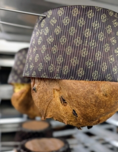 After baking, the panettone is hung upside down for 12 to 14 hours to ensure proper cooling. This is also done to maintain its domed shape.
