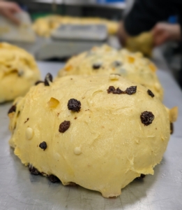 The domed discs are made and left to rise - each one is filled with fruits.