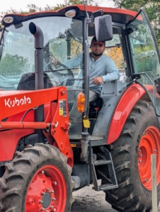 Here's Jimmy in my trusted Kubota tractor transporting buckets of rich mulch to the beds.