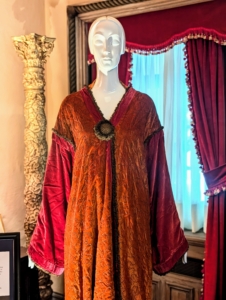 This evening coat is made of orange-red silk velvet with metallic embroidery and trim. Lucie loved to use bold colors and rich fabrics for her capes.