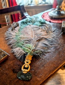 Lucie often used feather hand fans. She had them made in an array of different colors to match her clothing.
