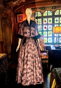 This silk satin hostess dress is flocked with velvet accents. While Lucie loved color, she often used some black for dramatic effect.