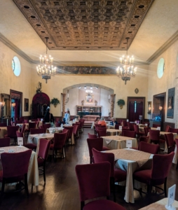 This is the Music Room at Caramoor. This room seats 170 guests and is known for its Renaissance furniture, Gothic tapestries, and stained glass elements. Depending on the time of year, the room is sometimes configured with theatre seating for views of the stage.