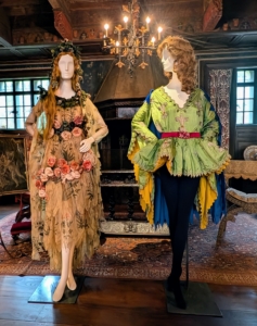 In the Spanish Alcove, a small space in the Music Room reserved for intimate gatherings and family games, were these costumes. On the left is a hand-painted Flora costume made of silk chiffon, silk organza, silk linen flowers, and metallic thread. It was what Lucie wore to the February 1924 Beaux Arts Ball, a high society fundraiser for the Beaux-Arts Architects. The costume was inspired by the painter Sandro Botticelli's, Primavera.
