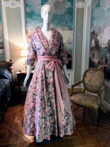 This is one of several day-dresses on display inspired by Christian Dior's "New Look" after the war. These dresses included floral prints, long, full skirts and fitted busts.