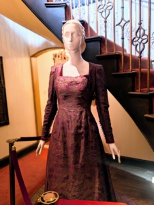 Lucie was more fond of finding her own fabrics and having them made into dresses than purchasing ready-to-wear garments. The fabric for this gown is made from magenta silk stamped with a silver pigment by Fortuny. The actual dress is said to be made separately with a custom fitted bodice and train.