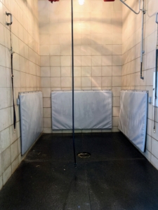 My Chows get washed in the stable. This horse shower stall is located at one end. It is a large stall with padded lower walls for animal safety. The faucets are housed in a cabinet on the right to keep them out of the way. The boom sprayer is very flexible and can swivel around easily.