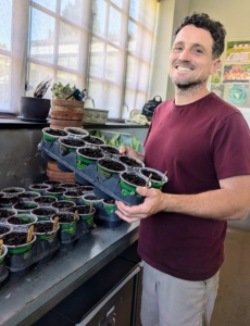 Ryan then transports the pots to an Urban Cultivator growing system, which has water, temperature and humidity all set up in a refrigerator like unit.