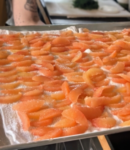 Meanwhile, grapefruit segments are placed on a sheet pan and chilled so they're ready when dessert is made.