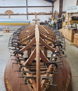 By November of 2024, the framing was clamped together to hold the bottom in place for planking.