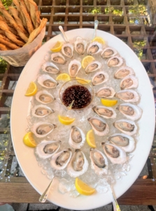 As guests arrived, they were offered cocktails and hors d'oeuvres, including fresh oysters with mignonette sauce out on the West Terrace.