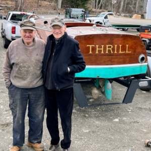 In 1989, Judy's father, Jay, took the boat out of retirement and began its first restoration. He enjoyed THRILL, cruising the coastal waterways of Maine for more than 10 years before being put in dry storage once again. Here is Jay in 2024 with THRILL and Cecil who helped him find a new owner who would appreciate both her history and heritage.