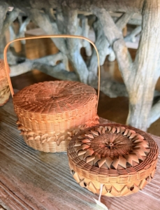 Today, the four Maine Indian tribes are the Maliseet, Micmac, Penobscot, and Passamaquoddy, known collectively as the Wabanaki, "People of the Dawnland." Jennifer Neptune, a citizen of the Penobscot Nation and Director of the Penobscot Nation Museum, brought a selection of baskets and other pieces handmade by Wabanaki Nation Citizens. On the left is what is likely an 1800s child size lunch basket with its handle for carrying. It's made with black ash splints, which is very strong and very flexible. In fact, black ash is such a popular tree to use for weaving baskets because pieces can be thick or sliced very thin like paper. The other basket is also made from black ash and is decorated on top with "diamond curls." This basket could have been used to store mens' collar stays.