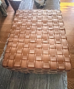 This is a weaved box basket, likely made in the 1920s or 1930s from black ash. It may have been used to store paper.