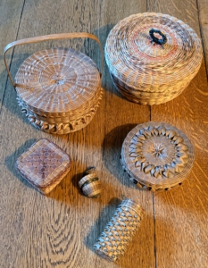 These are more storage baskets made by Penobscot Nation citizens. Early basket makers would sell the pieces door to door and bring along miniature samples.