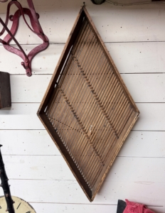 On this wall is an interesting diamond-shape basket. Walking through an antiques shop gives visitors a glimpse of what was handmade or popularly used during a certain time.