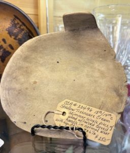 This is a Treenware Cream Skimmer. Treen, literally "of a tree" is a generic name for small handmade functional household objects made of wood. A cream skimmer is a tool used to separate cream from milk by lifting or skimming the fat layer that rises to the top. This one dates back to the 18th or 19th century.