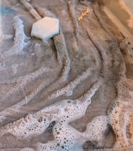 All the cleaning is done on a terry cloth towel lining the bottom of the sink, so the metal doesn’t bang against any surfaces. The towel is also a good idea to use when washing special china… just in case anything slips through the fingers.