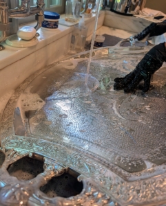 Then rinses off the cream and washes it with dish soap and water.