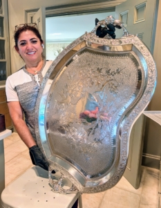Here's Enma with the freshly polished tray. Another tip – never clean silver in the dishwasher. The detergents’ aggressive chemicals, combined with the washer’s high cleaning temperature, will eventually turn it grey or white, with a dull, non-reflective surface.