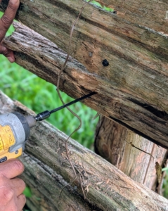 New screws are drilled into the cross pieces to keep them in place.